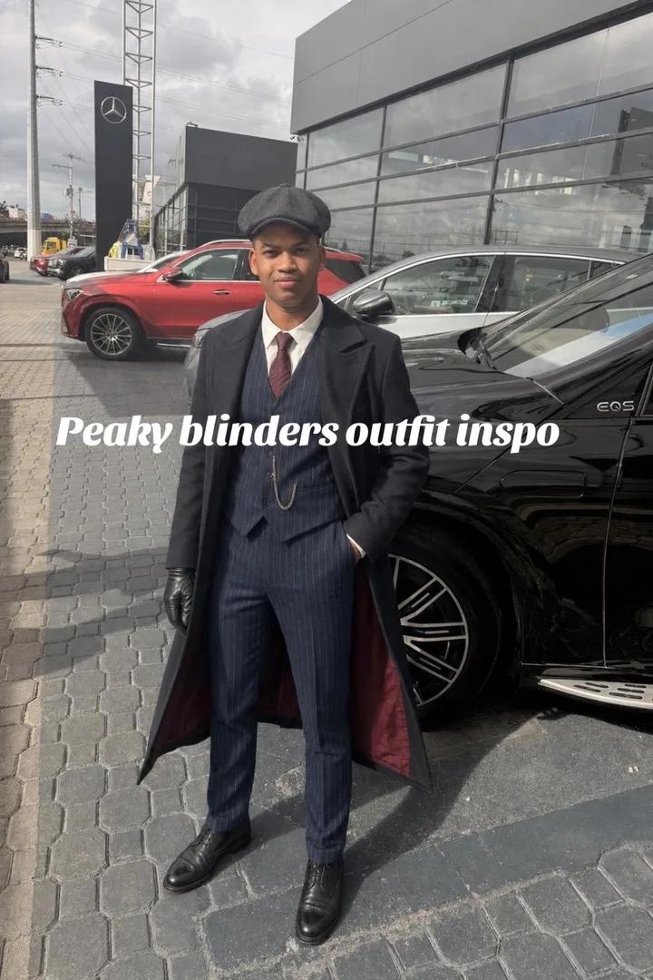 The same photo restyled in a dark three-piece suit, tie, and flat cap